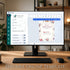 Computer monitor displaying an editable online template with a birthday invitation design on a desk.