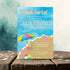 Beach party invitation with colorful design on a wooden surface