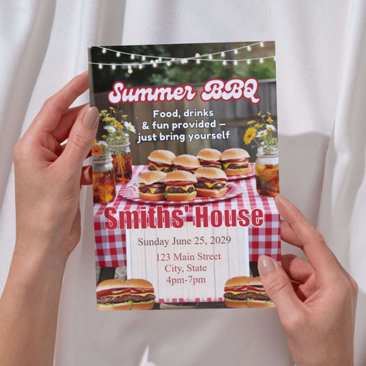 Hand holding a Summer BBQ invitation with burgers and a checkered tablecloth design.
