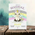 Invitation card with a unicorn design on a wooden surface