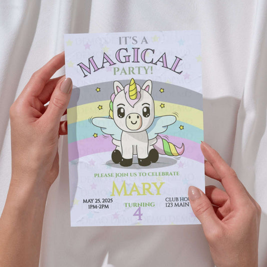 Invitation card with a unicorn design held by hands against a white background
