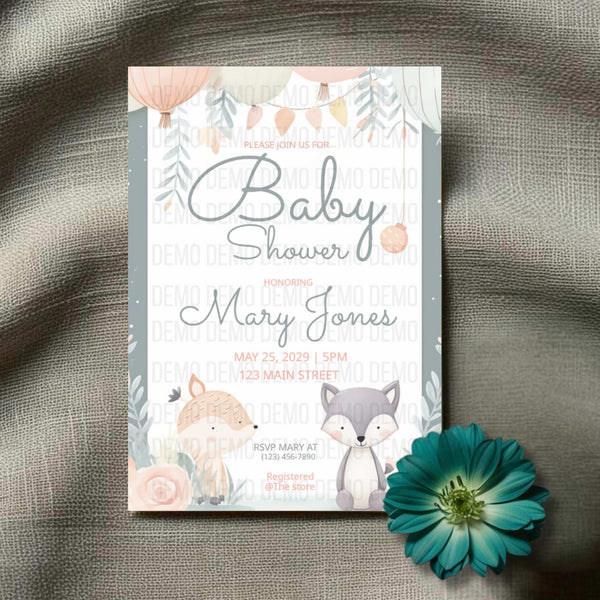 Baby shower invitation with fox and floral design on a textured surface with a flower.