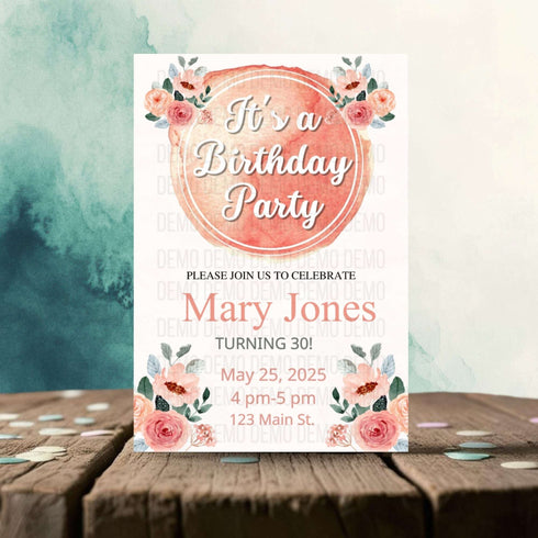 Birthday party invitation with floral design on a wooden surface