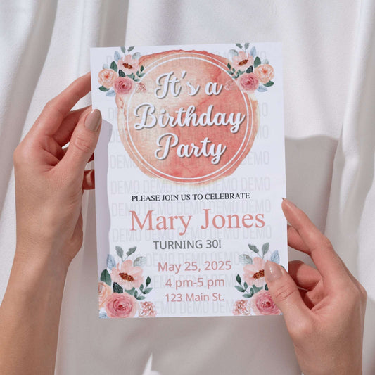 Birthday party invitation held by hands with floral design