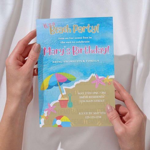 Hand holding a beach party birthday invitation with colorful design