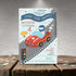 Children's birthday party invitation with a race car theme on a wooden surface.