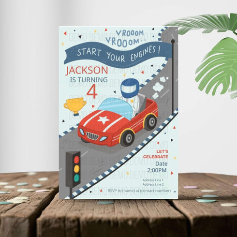 Children's birthday party invitation with a race car theme on a wooden surface.
