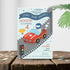 Children's birthday party invitation with a race car theme on a wooden surface.