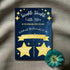 A personalized baby shower invitation with a twinkling star theme, including custom text for the event details.