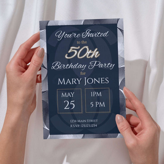 Navy blue birthday party invitation held by hands against a white curtain background
