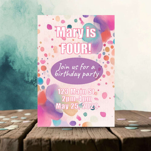 Birthday party invitation with colorful polka dots on a wooden surface