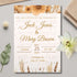 Wedding invitation card with floral design on a light gray surface