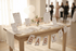 Baby shower setup with a table, baby shower decorations, and blurred people in the background.