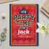 Party invitation card for 'It's Party Time for Jack' on a decorative surface with flowers and leaves.