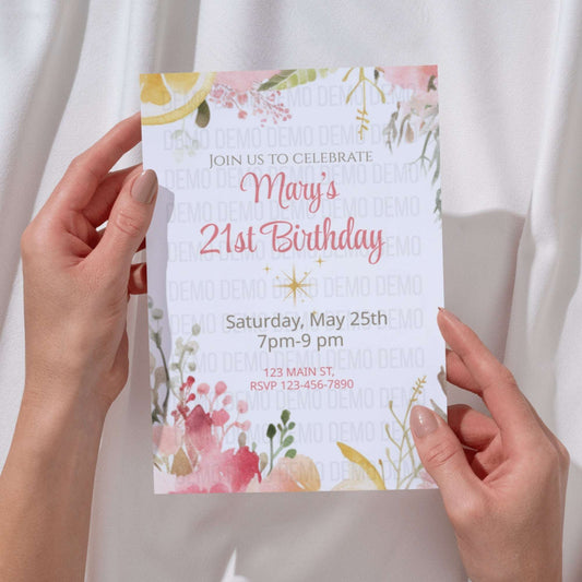 Hand holding a birthday invitation card with floral design