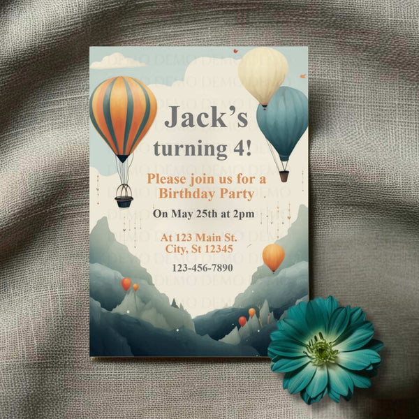 Birthday party invitation with hot air balloons and mountains on a textured surface with a flower.