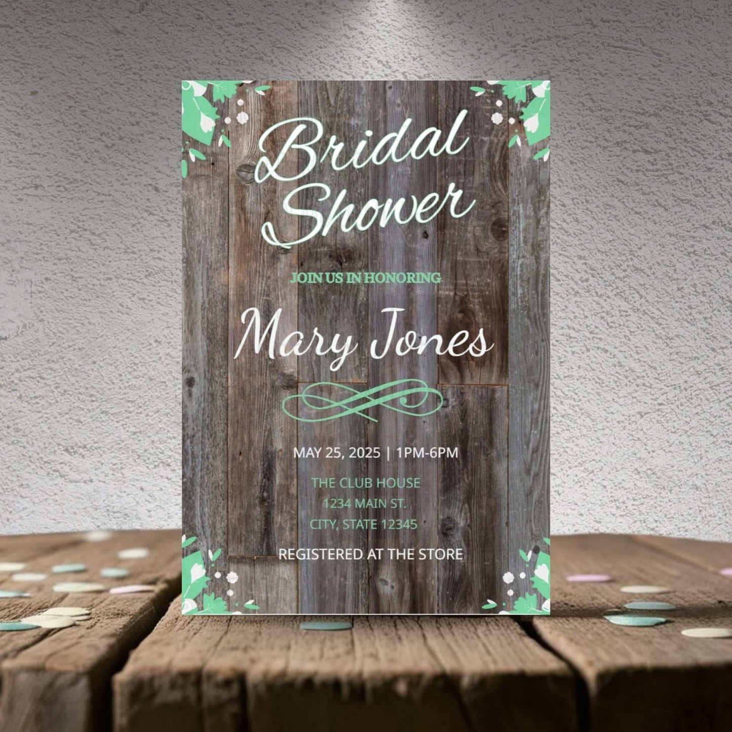 Bridal shower invitation with wooden design and floral elements on a textured surface.