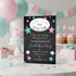 A baby shower invitation card styled on a white table with pastel balloons, cupcakes, and gifts in the background. The invitation has a black chalkboard background with pink, teal, and white stars and text reading 'Twinkle Twinkle Little Star' and 'How we wonder what you see!'.