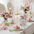 Elegant table setting with pink roses, macarons, and a 'Thank You' card.