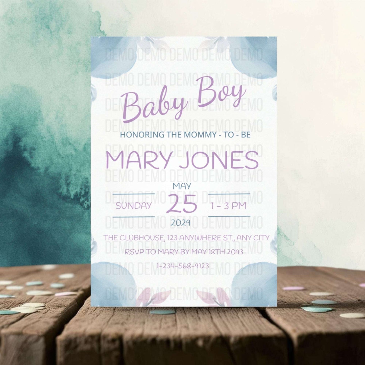 Baby shower invitation card for a baby boy on a wooden surface with watercolor design