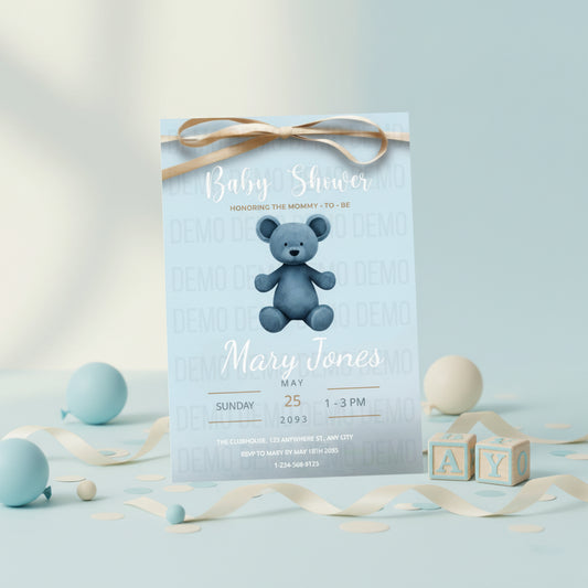 Baby shower invitation with a blue teddy bear on a light blue background, surrounded by decorative ribbons and blocks.