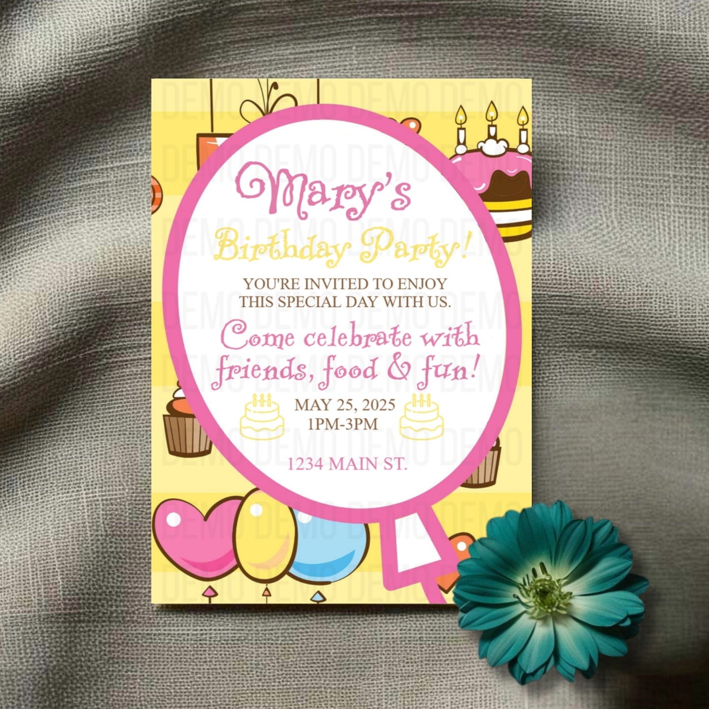 Birthday party invitation with colorful design on a textured surface with a flower.