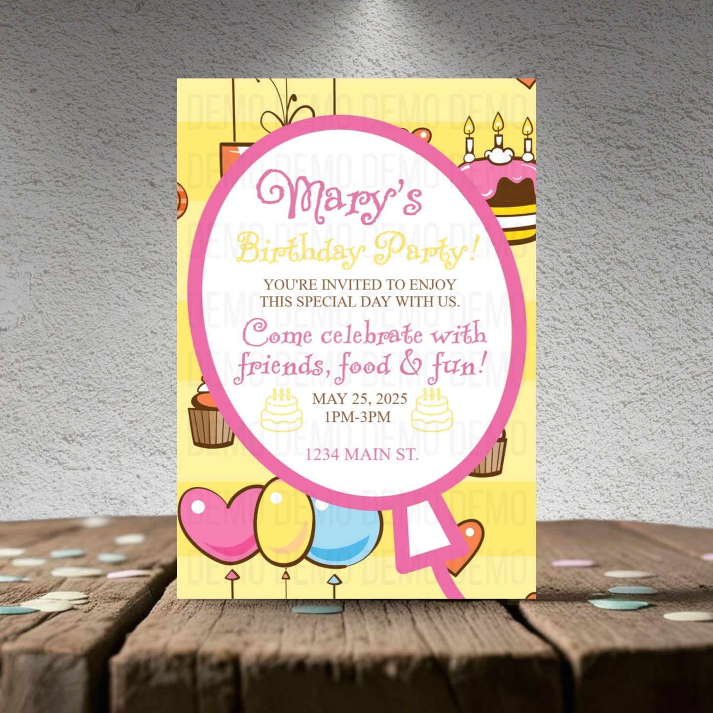 Birthday party invitation card with colorful design on a wooden surface