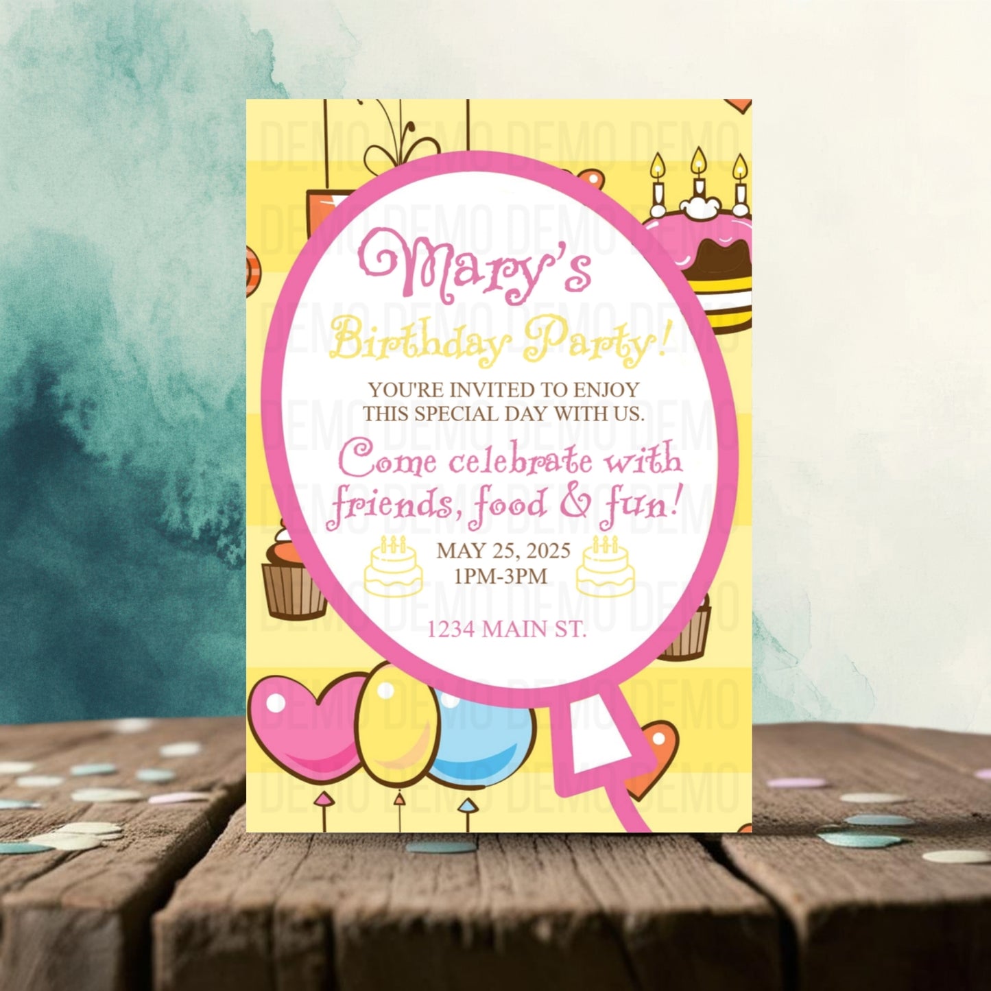 Birthday party invitation card with colorful design on a wooden surface