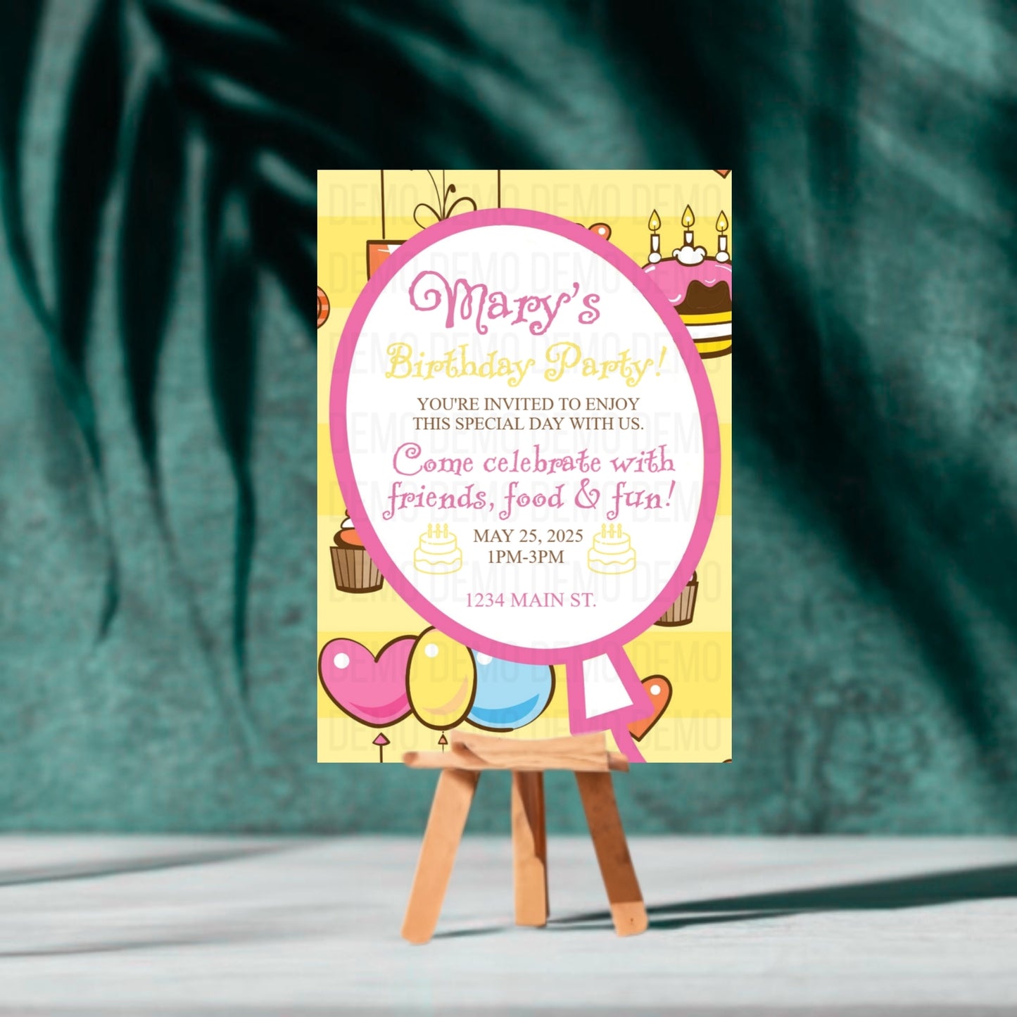 Birthday party invitation card on a stand with a green leafy background