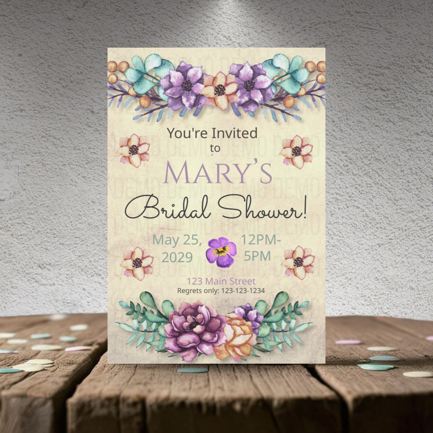 Bridal shower invitation with floral design on a wooden surface