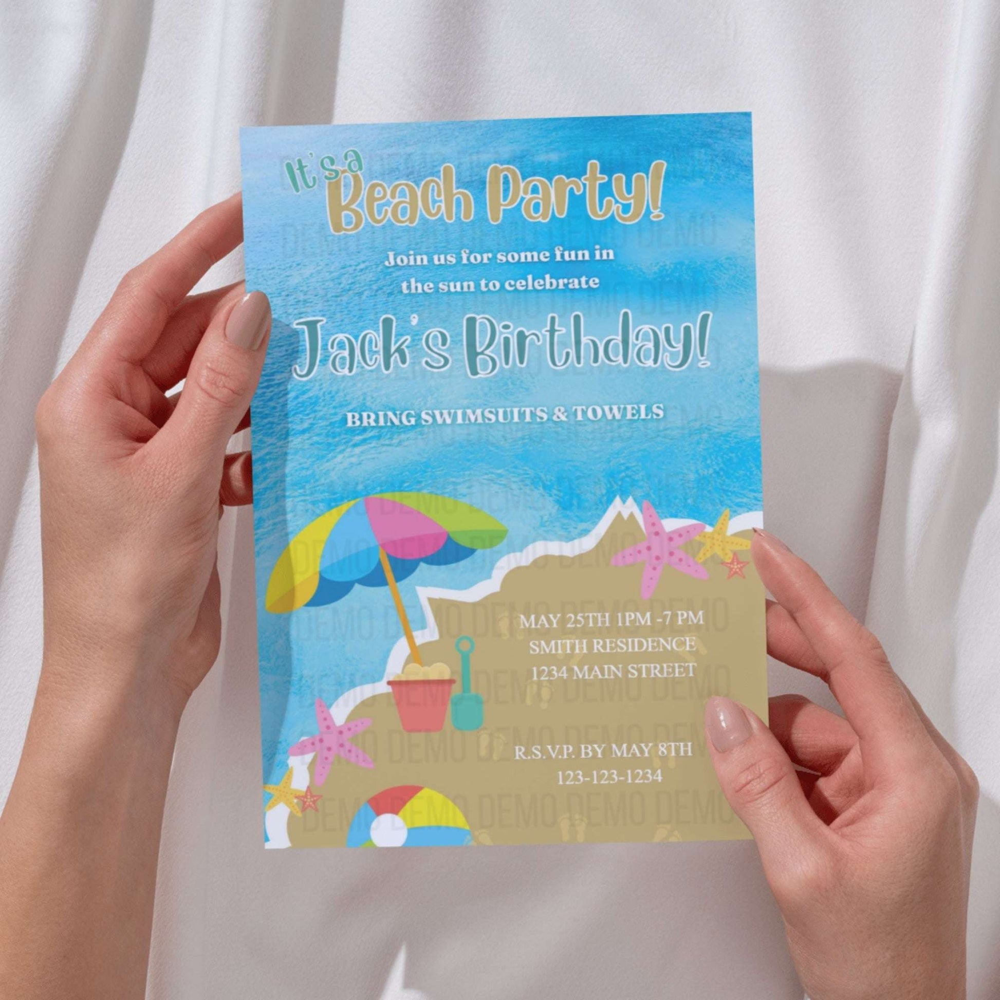 Hand holding a birthday party invitation with beach theme