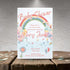 Baby shower invitation with rainbow and baby elements on a textured surface