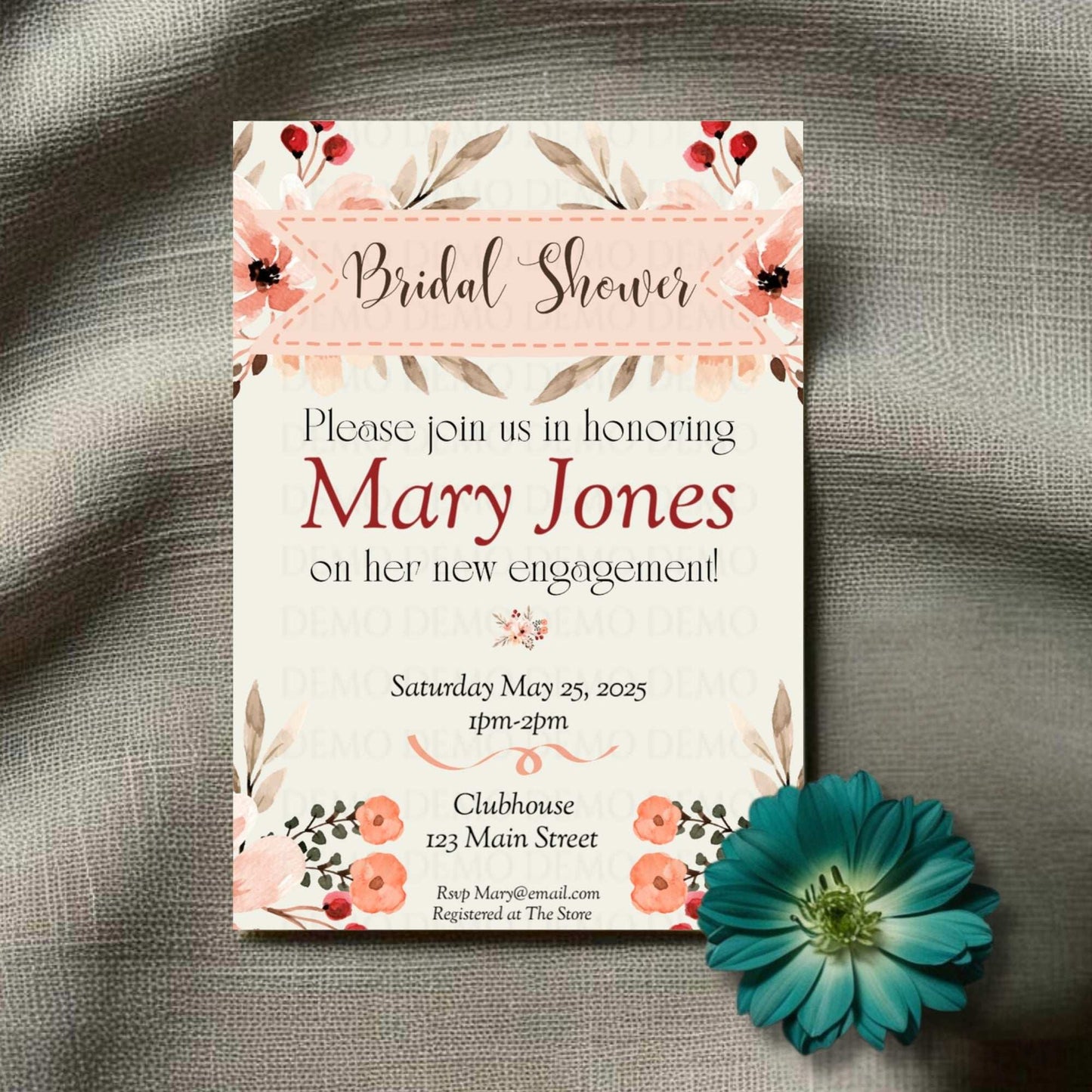 Bridal shower invitation with floral design on a textured surface with a blue flower.