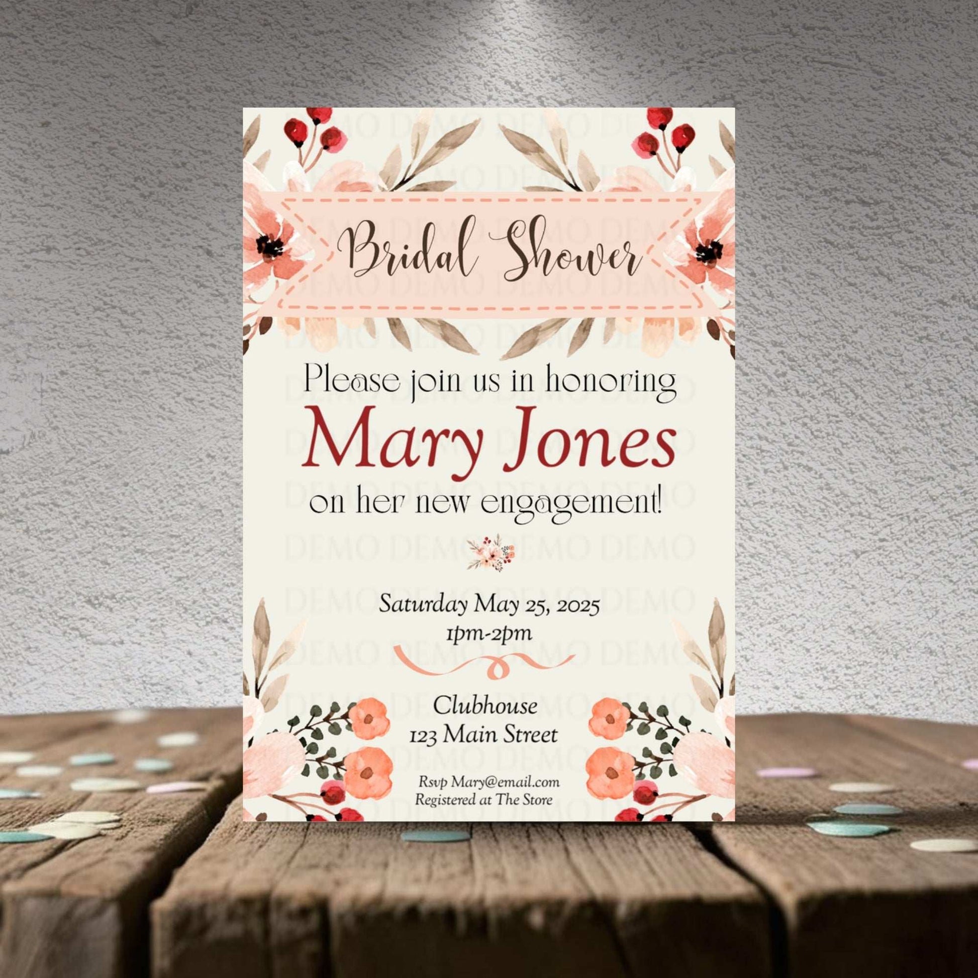 Bridal shower invitation with floral design on a wooden surface and gray background