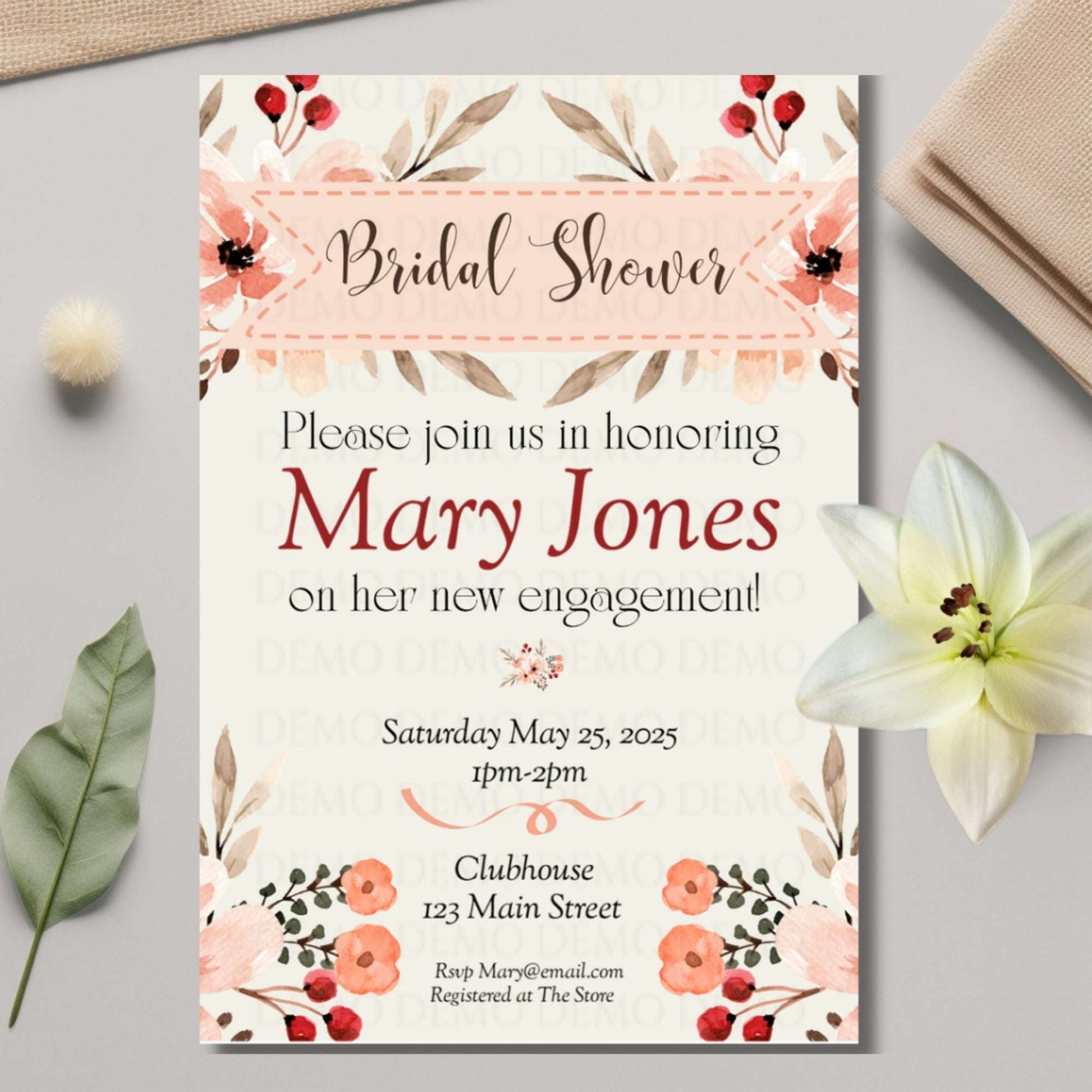 Bridal shower invitation with floral design on a light gray surface with flowers and leaves.