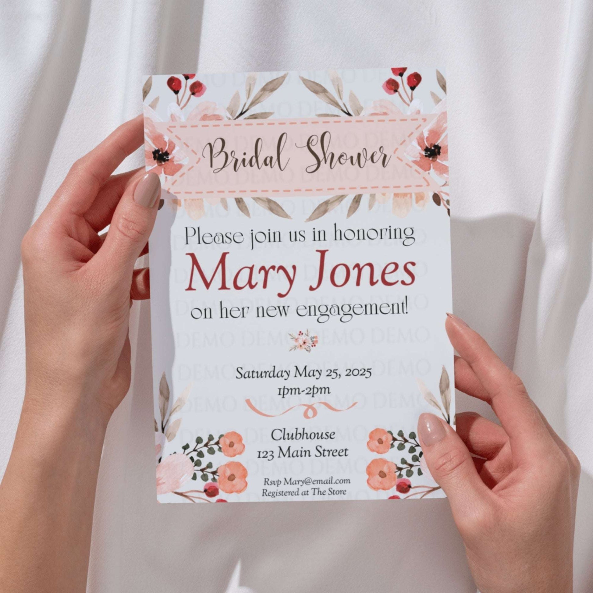 Bridal shower invitation held by hands with floral design
