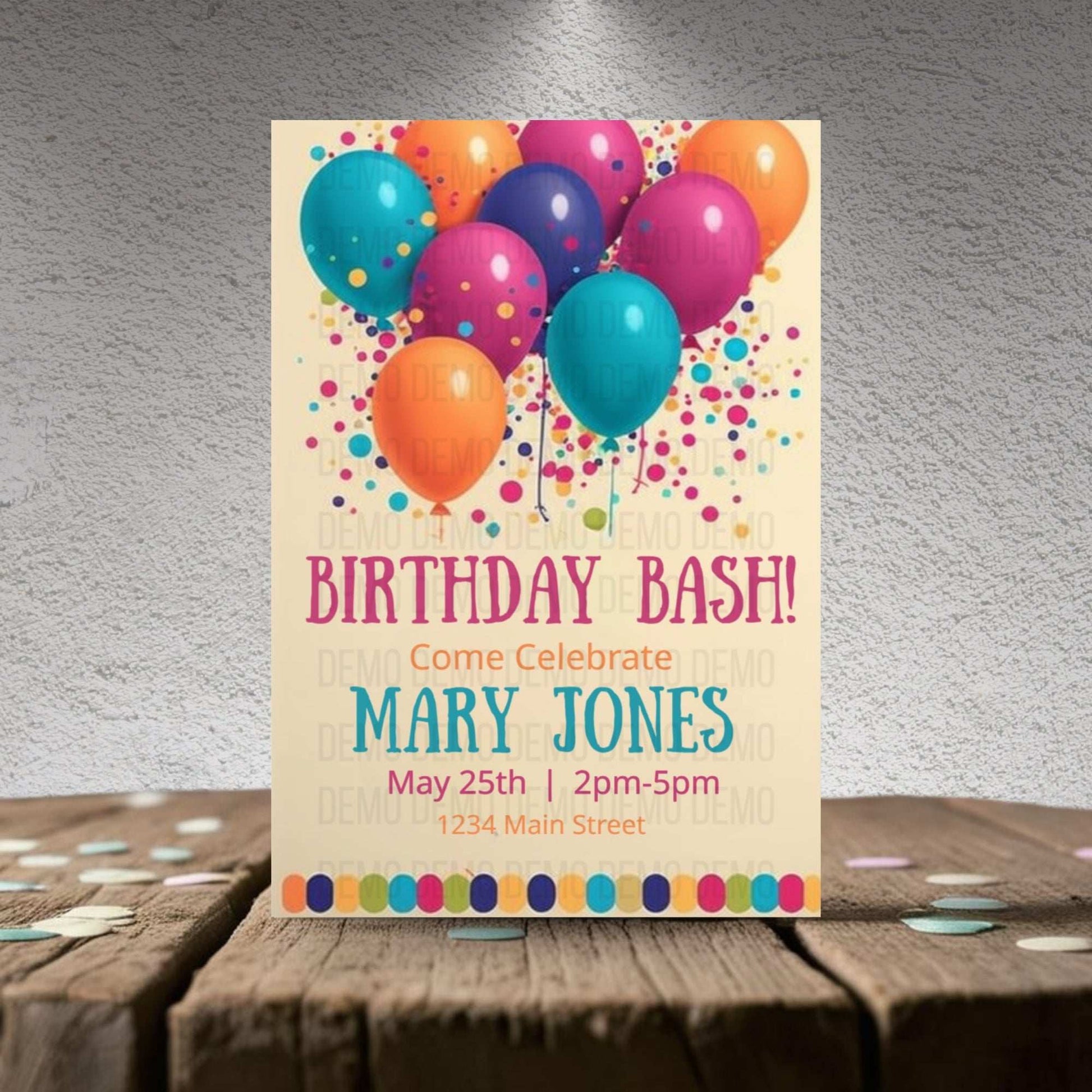Birthday bash invitation with colorful balloons on a wooden surface