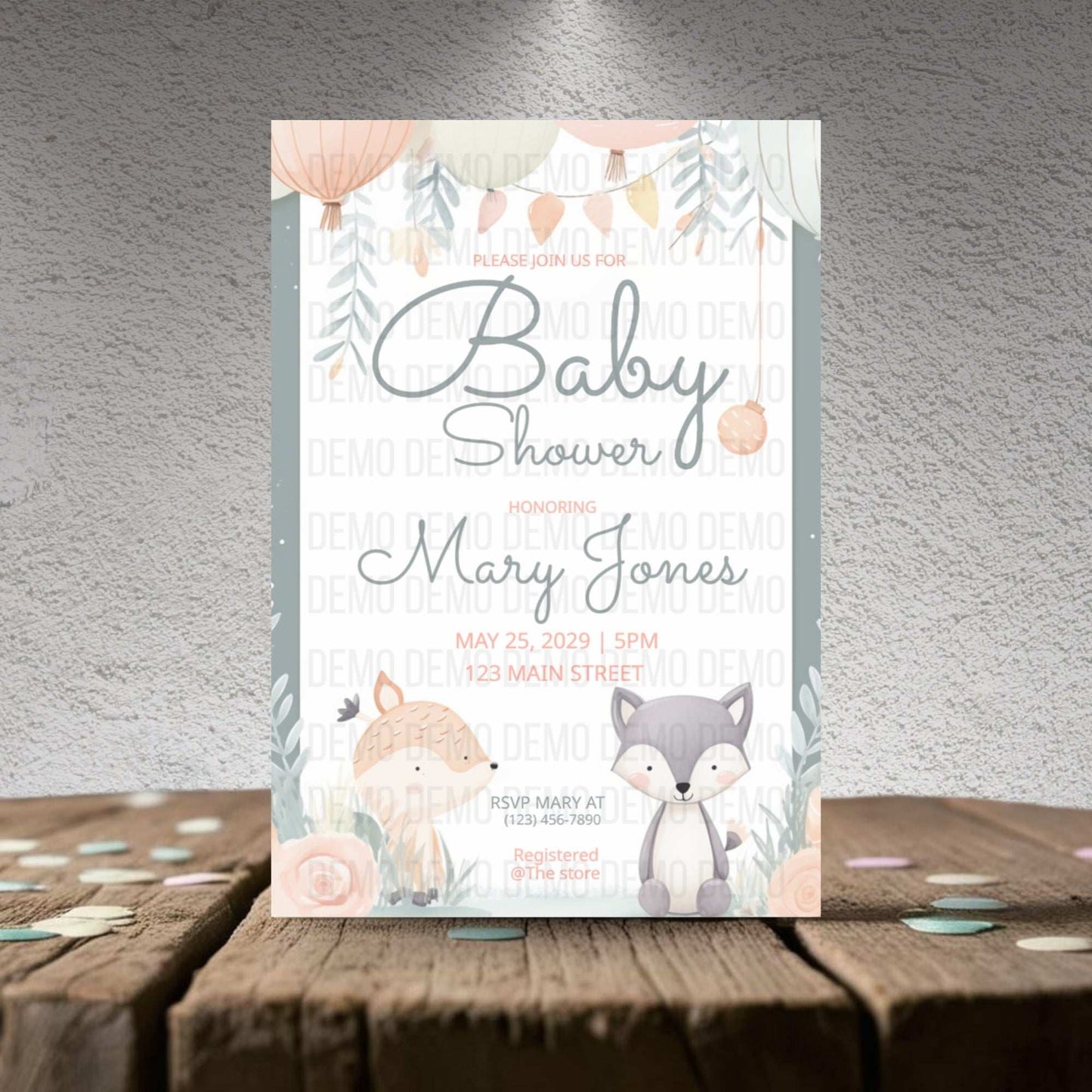 Baby shower invitation with foxes on a wooden surface and gray background