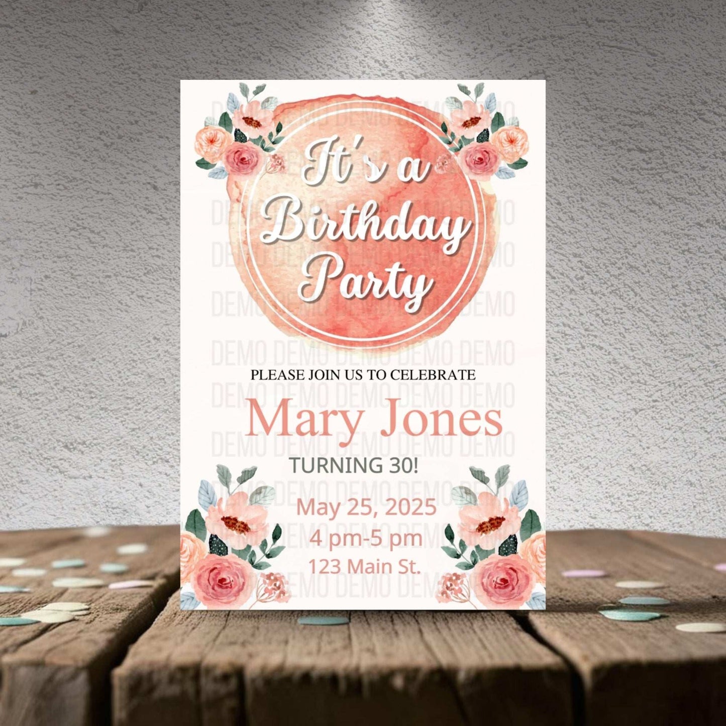 Birthday party invitation with floral design on a wooden surface
