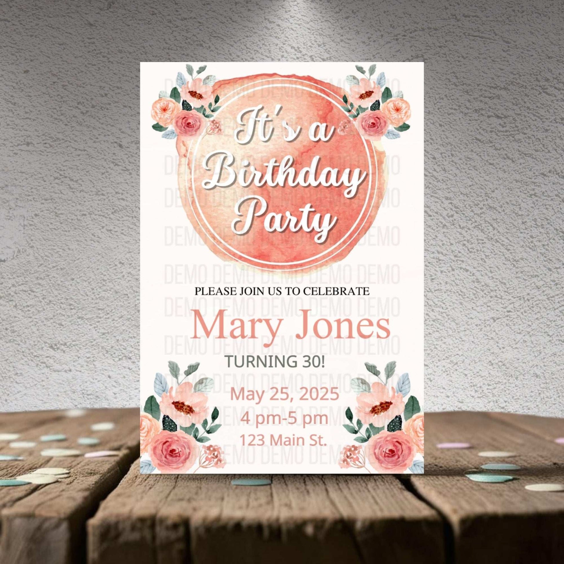 Birthday party invitation with floral design on a wooden surface
