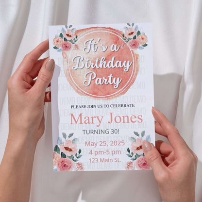 Birthday party invitation held by hands with floral design