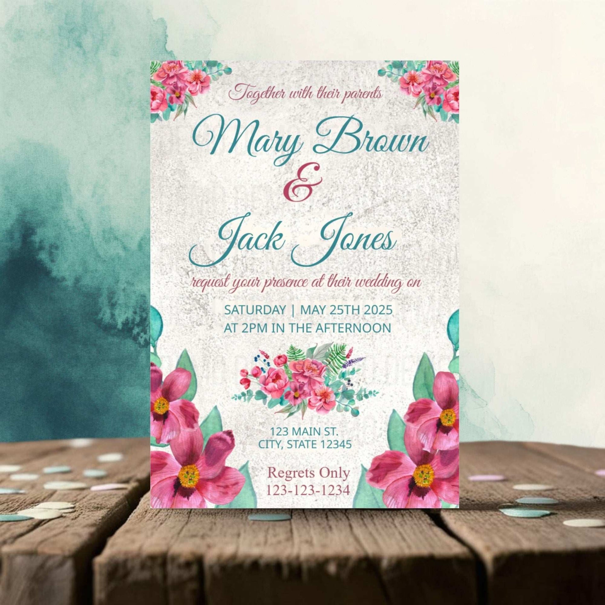 Wedding invitation card with floral design on a wooden surface