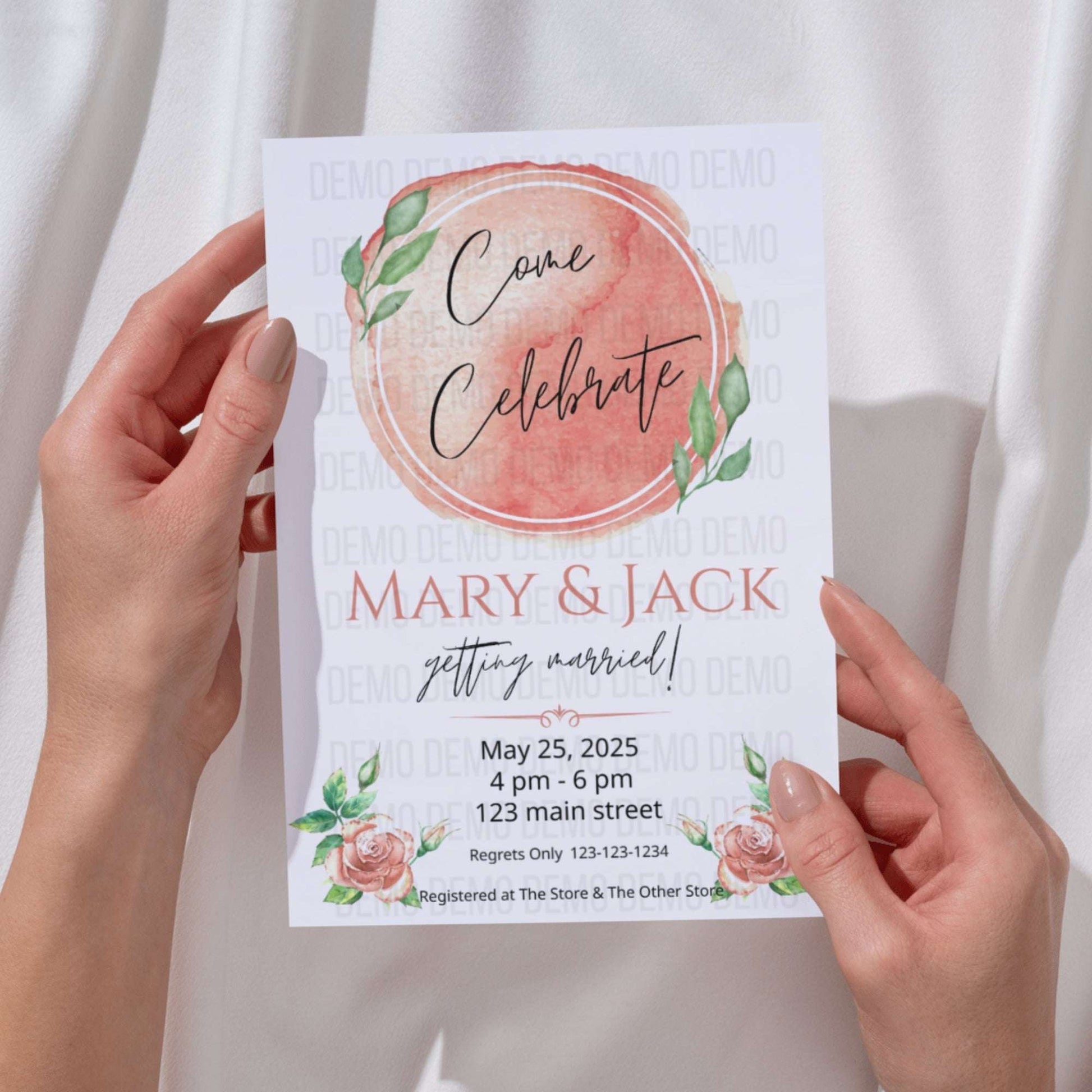 Hand holding a wedding invitation with floral design and text.