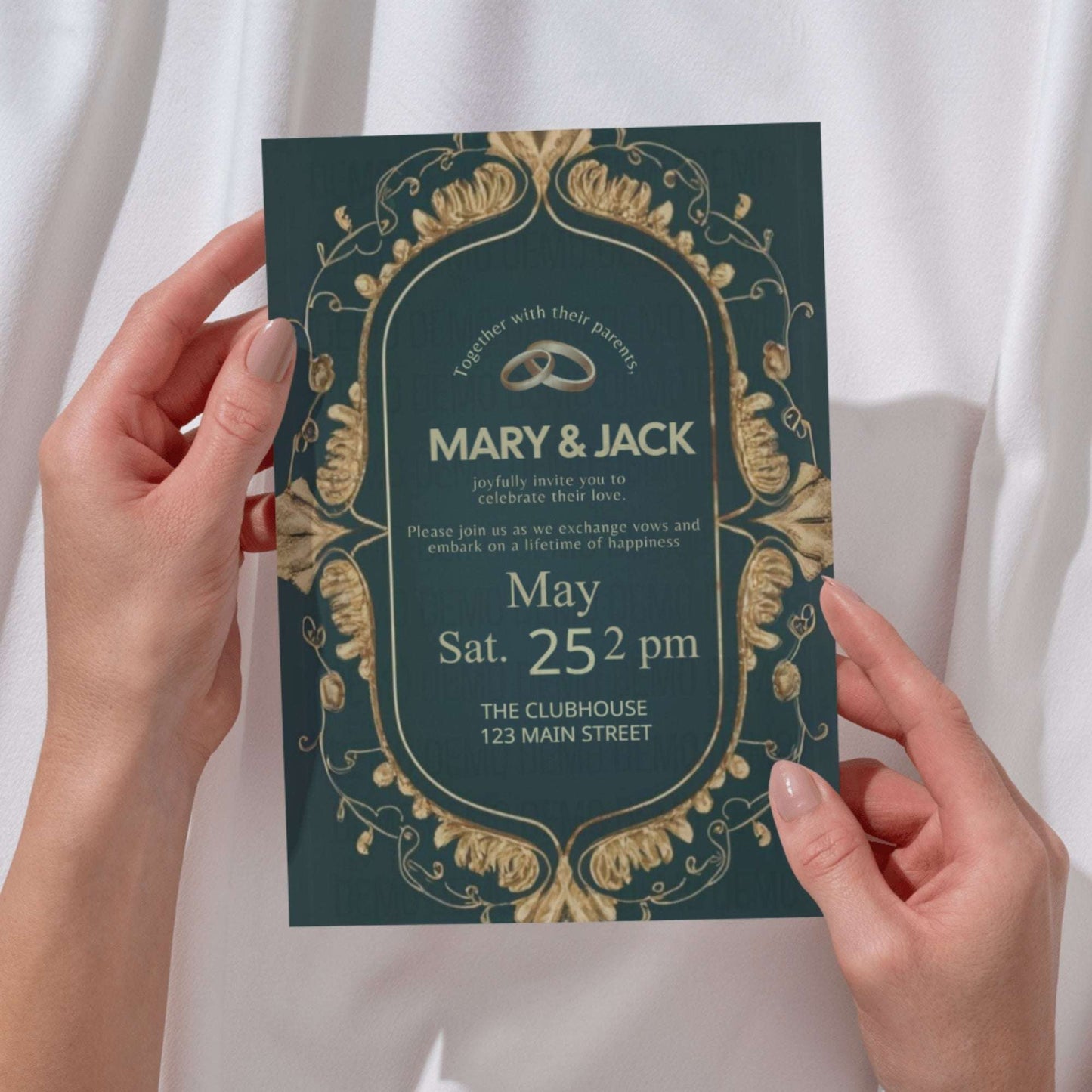 Wedding invitation card held by hands with decorative gold design on a white background