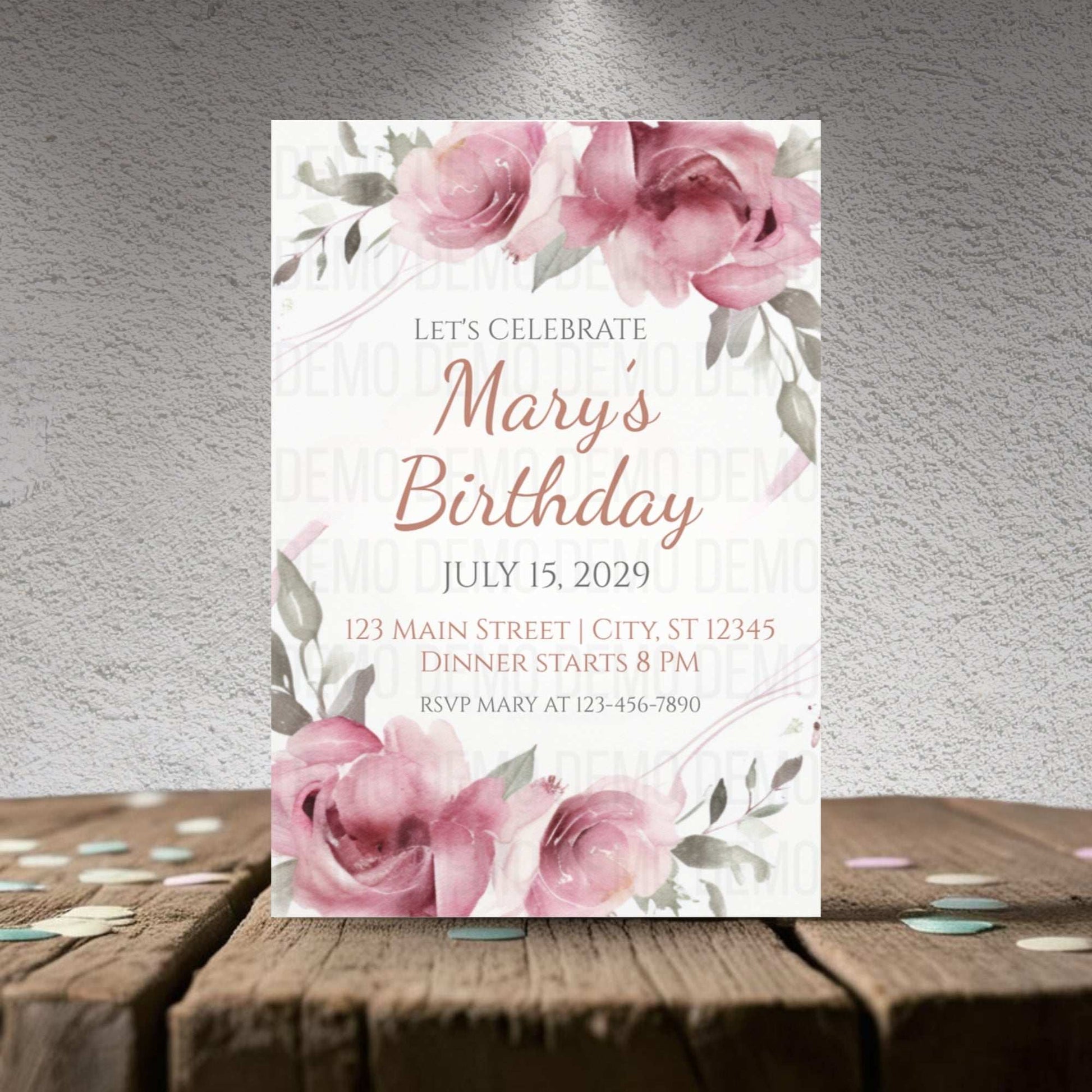 Birthday invitation card with pink roses on a wooden surface and gray background