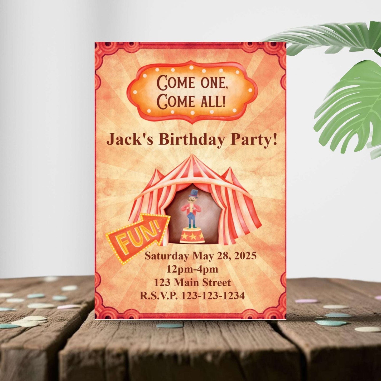 Birthday party invitation with a circus theme on a wooden surface.