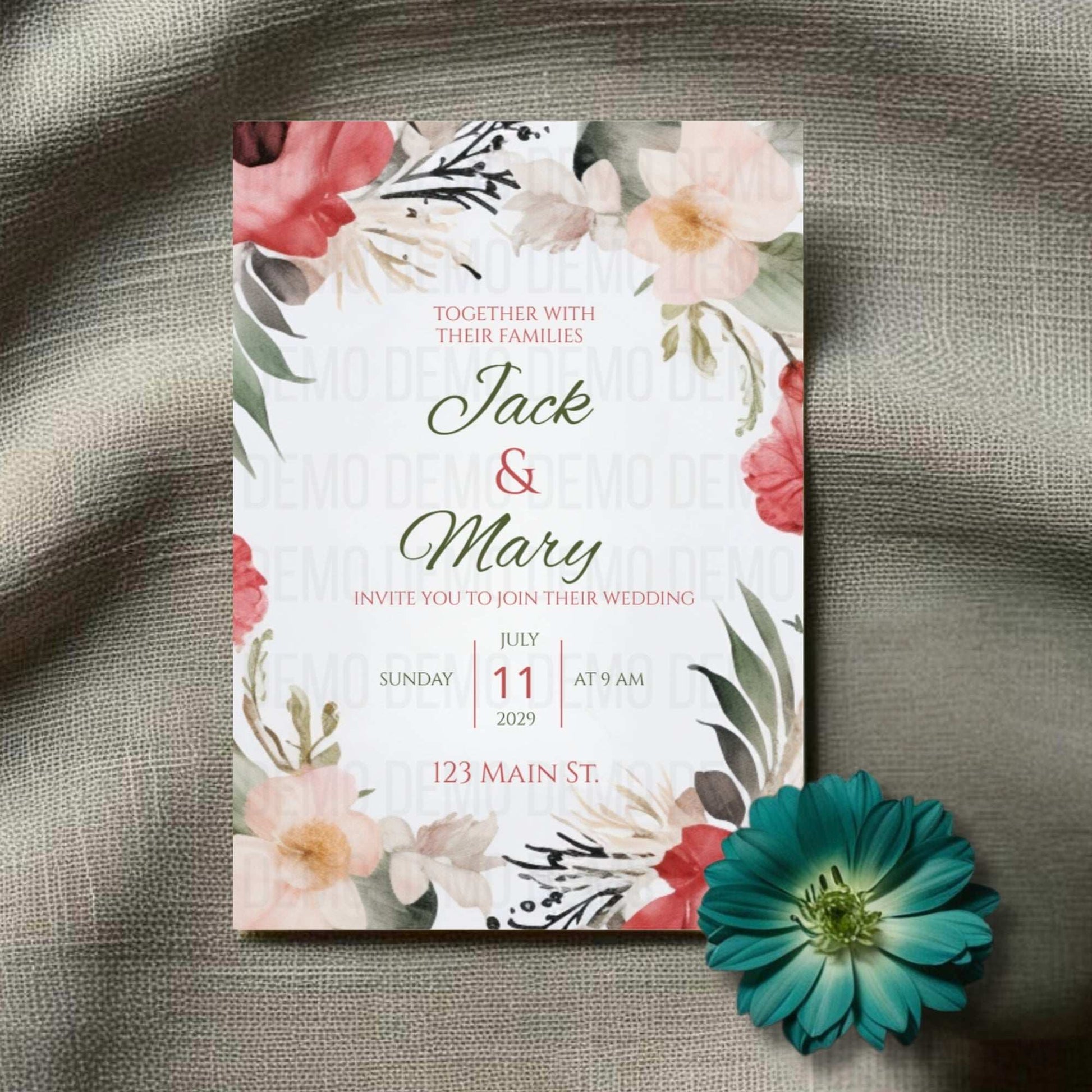 Floral wedding invitation with a green flower on a textured surface