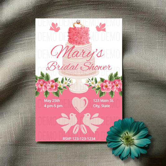 Bridal shower invitation with cake design and floral elements on a textured surface.