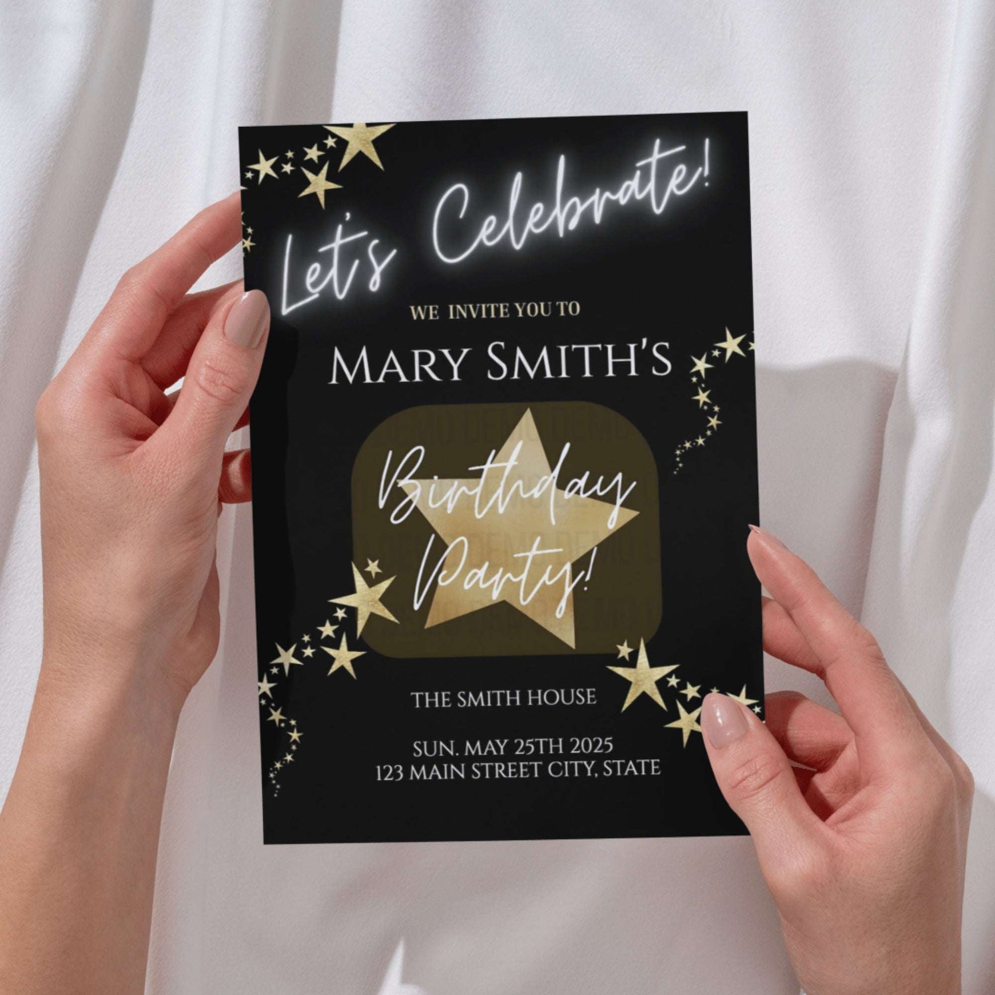 Birthday party invitation card with gold text and stars held by hands against a white background
