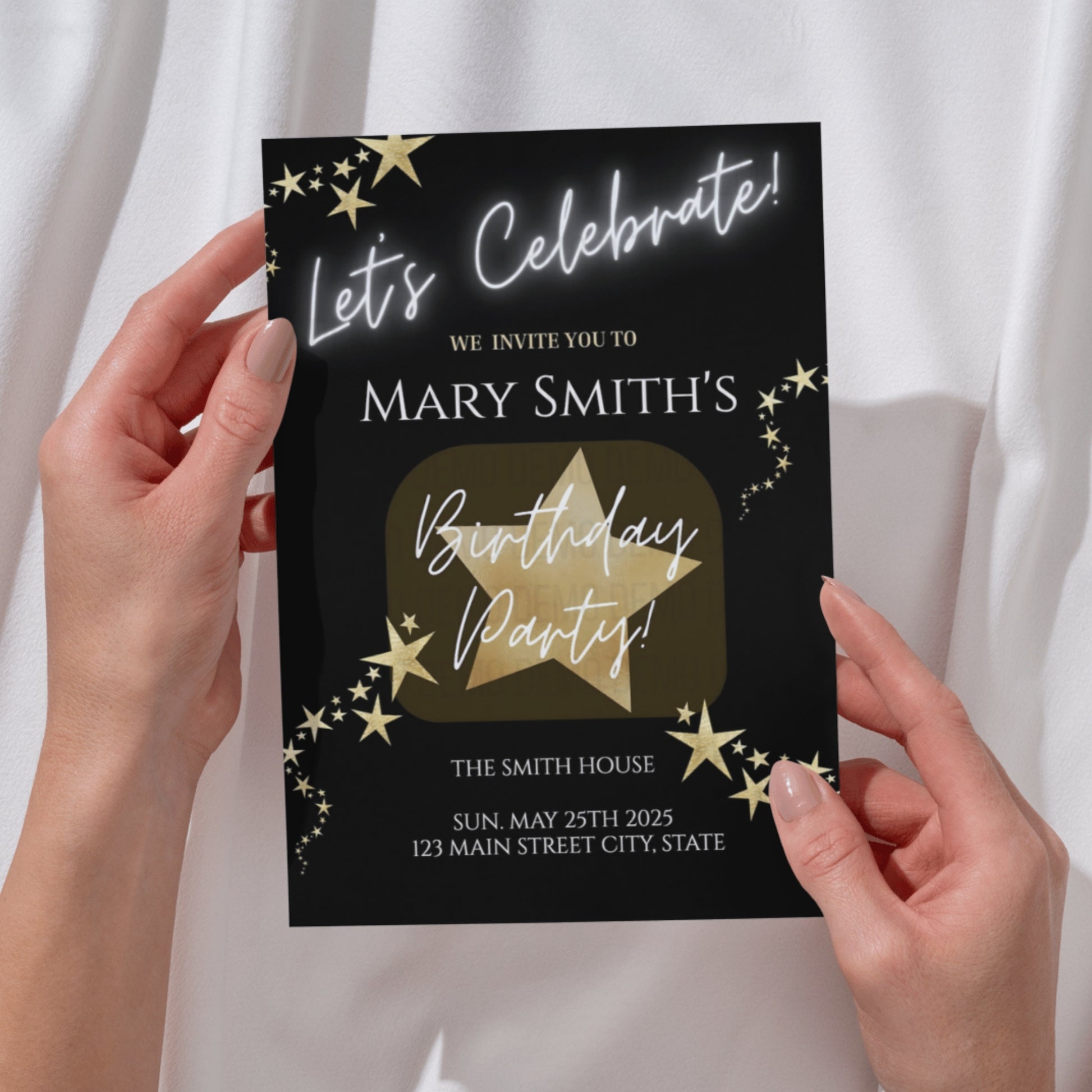 Birthday party invitation card with gold text and stars held by hands against a white background